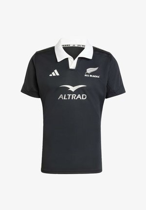 Zwarte rugbyshirt met een witte kraag. Heeft witte logo's: "All Blacks" en "ALTRAD." Gemaakt van een gladde, lichte stof.