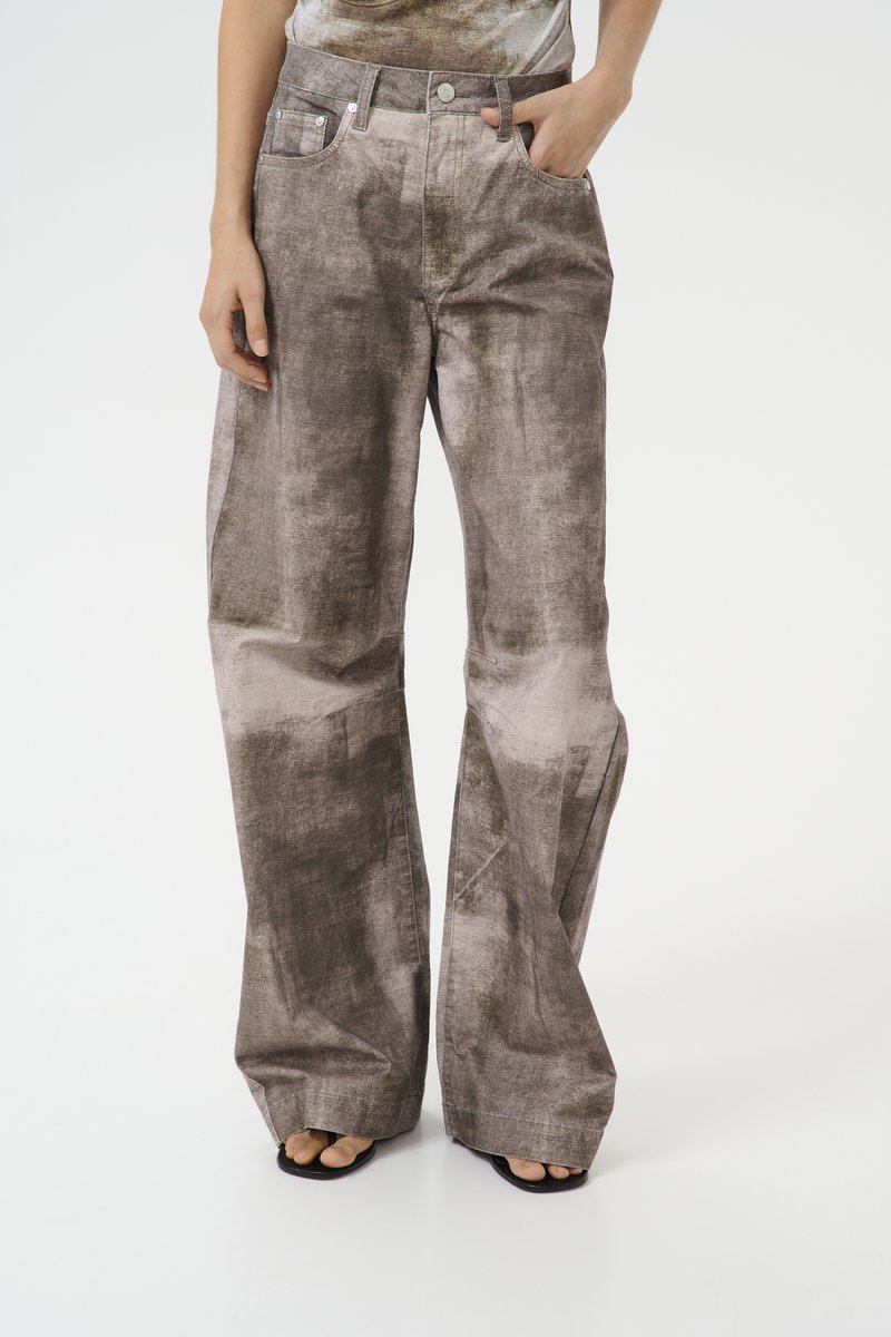 Wide-leg pants in a textured, mottled grey fabric. Features include a high waist, front pockets, and subtle stitching details.