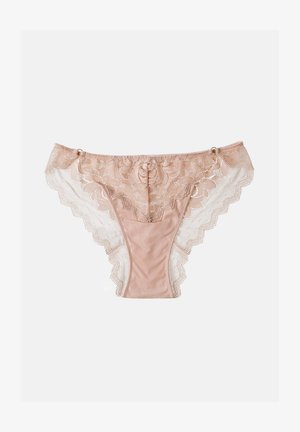 Beige lace panties with floral patterns and mesh sides, featuring scalloped edges and small decorative rings near the waistband.