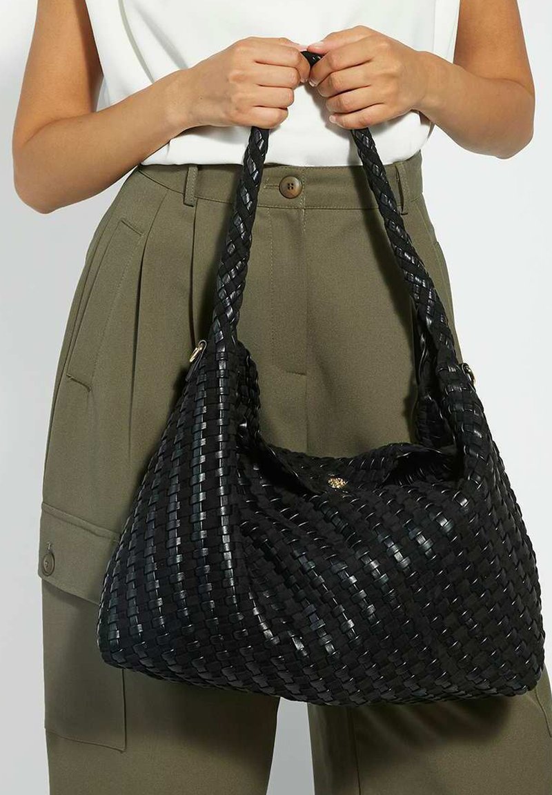 Black woven shoulder bag with a soft, slouchy shape. Features braided handles and a subtle sheen. Ideal for casual or everyday use.