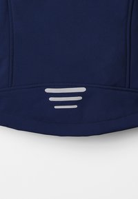 Navy blue garment with smooth fabric, featuring a rounded bottom hem and reflective silver accent stripes near the lower edge.