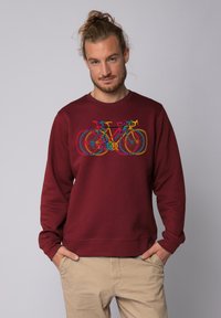 Bordeaux sweatshirt van katoenmix met een ronde hals. Voorzien van een multicolore fietsdruk aan de voorkant. Gestructureerde afwerking.