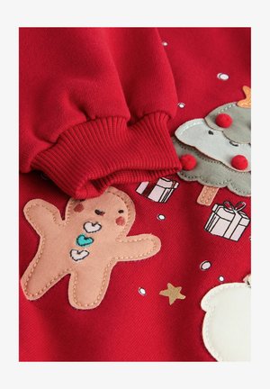 Rode sweatshirt met motieven van een peperkoekmannetje, een kerstboom en cadeaus, met textuur-applicaties en geribde manchetten.