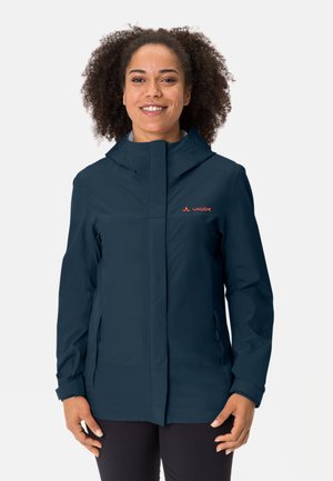 Navy waterproof jacket with a zip front, hood, and side pockets. Features a smooth texture and contrasting orange logo on the chest.