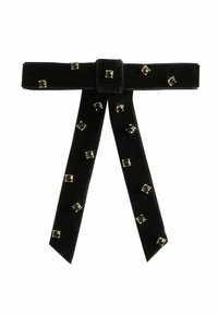 Black velvet ribbon belt with gold accents, featuring rectangular black gems. Ribbon has a central knot and two long, trailing ends.