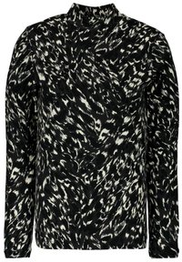 Czarnobiały wzorzysty top z długim rękawem i wysokim dekoltem. Materiał ma miękką fakturę z wirującymi, abstrakcyjnymi wzorami.