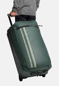 Valigia verde con dettagli grigi, design aerodinamico, strisce verticali, maniglia superiore e materiale resistente. Chiusura con zip visibile.