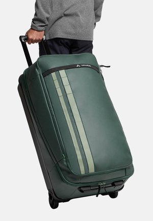Green wheeled suitcase with gray accents, a streamlined design, vertical stripes, a top handle, and durable material. Zipper closure visible.