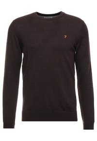 Maglione lavorato a maglia marrone scuro con maniche lunghe, collo rotondo e un piccolo logo dorato sul petto. Tessuto morbido e design aderente.