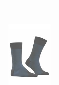 Graue knielange Socken mit blauen Akzenten. Rippstrickstruktur, verstärkter Fersen- und Zehenbereich. Glatter Stoff mit leichtem Glanz.