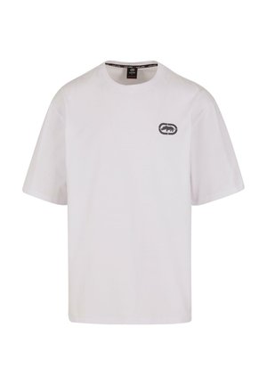 Camiseta blanca de manga corta hecha de algodón, con un pequeño gráfico de logo gris en el lado izquierdo del pecho. Diseño clásico de cuello redondo.