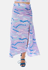 Purple maxi skirt with abstract blue and pink patterns, side slit, gathered detail at waist, made from lightweight fabric.