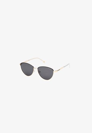 Cat-eye sunglasses with black lenses, gold metallic frame, clear temple tips, and adjustable nose pads for comfort.