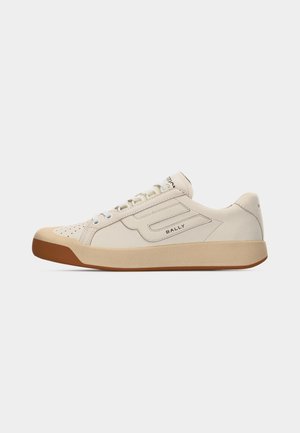 Low-top beige leather sneaker with perforated toe, lace-up front, rubber sole, and "Bally" logo on side and heel.