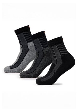 Four pairs of mid-calf athletic socks in black and varying shades of gray with ribbed cuffs and patterned knit sections.