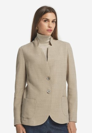 Beige textured blazer with a shawl collar, two front pockets, and two button closure. Smooth fabric with a structured fit.