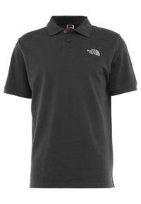 Polo noir en coton, avec col, manches courtes et logo brodé sur la poitrine gauche. Coupe classique et lisse.