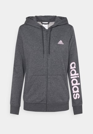 Donkergrijze hoodie met volledige ritssluiting, voorzakken, capuchon met trekkoord, klein Adidas-logo op de borst en grote roze "adidas"-tekst op de linkermouw.