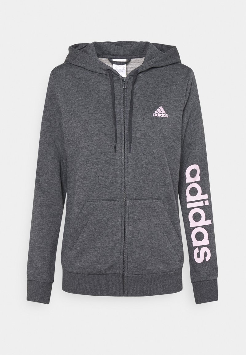 Sweat à capuche zippé intégral gris foncé avec poches avant, capuche à cordon de serrage, petit logo Adidas sur la poitrine, et grand texte rose "adidas" sur la manche gauche.