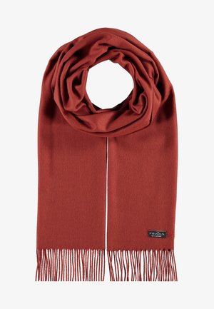 Weicher, rostfarbener Wollschal mit Fransen an den Enden und einem kleinen schwarzen Etikett, das nahe einer Kante angenäht ist.