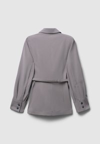 Light gray tailored jacket with a notched collar, long sleeves, and a tied belt at the waist. Features buttoned cuffs and a smooth texture.