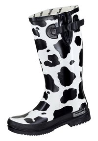 Black and white rubber rain boot with cow print design, featuring a textured black sole and a side strap with buckle detail.