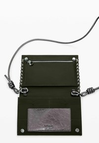 Olive green leather wallet with a silver zipper pocket, a metallic card slot, decorative stitching, and a detachable cord strap.