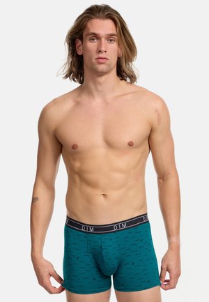 Türkise Boxershorts mit einem schwarzen Bund, auf dem "DIM" steht, und einem dezenten, sich wiederholenden Logomuster im gesamten Stoff.