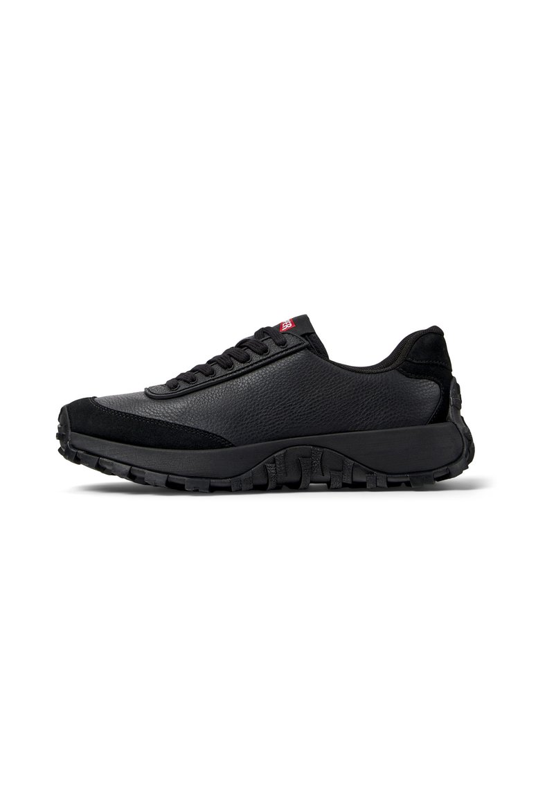 Black athletic shoe featuring a textured leather and suede upper with a padded collar, lace-up closure, and a thick, rugged outsole.