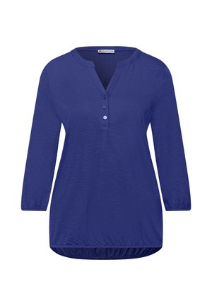 Damska niebieska bluzka z długim rękawem, dekoltem w serek zapinanym na trzy guziki oraz marszczonym, elastycznym dołem i mankietami, gładka tkanina, styl casual.