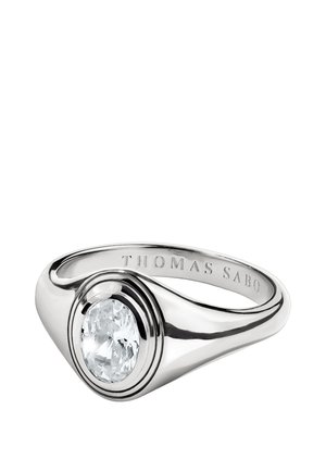 Silberner Siegelring mit einem großen, runden, klaren Edelstein in der Mitte, mit der Gravur "THOMAS SABO" auf der Innenseite des Rings.