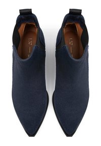 Dark navy suede ankle boots with a pointed toe, elastic side panels, and a small pull tab at the back. Flat black soles.
