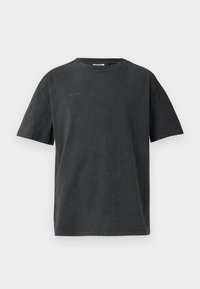 Black cotton t-shirt with a rounded neckline and short sleeves. Features a slightly textured finish and minimalistic logo detail on the front.