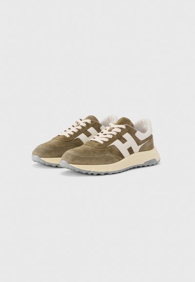 Αθλητικά παπούτσια από σουέντ σε ελιά πράσινο με λευκές λεπτομέρειες, στρογγυλή μύτη, σχέδιο με κορδόνια και υφασμένο λαστιχένιο εξωτερικό πέλμα. Διαθέτουν εμφανές λογότυπο στο πλάι.