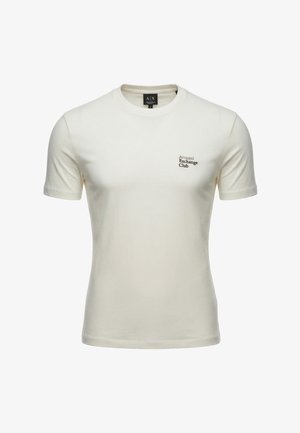 T-shirt blanc cassé à manches courtes et col rond avec un petit texte "Armani Exchange Club" sur le côté gauche de la poitrine.
