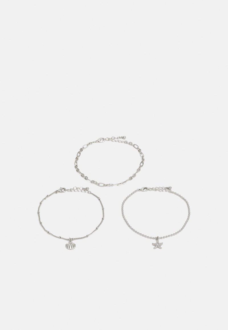Tre braccialetti d'argento: uno con un design a catena, uno con piccole perle e uno con un charm a forma di stella marina, tutti con chiusure regolabili.