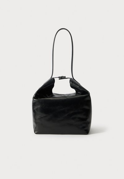 Black leather handbag with a structured shape, featuring a single long handle and a fold-over top. Smooth texture, minimal hardware.
