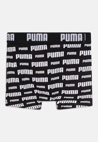 Črne bokserice z belo potiskano "PUMA" logo po celotni površini, elastičen pas z "PUMA" blagovno znamko, gladka tekstura tkanine.