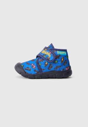 Blue fabric shoe with a velcro strap, featuring a colorful car pattern and a rubber sole, designed for comfort and flexibility.