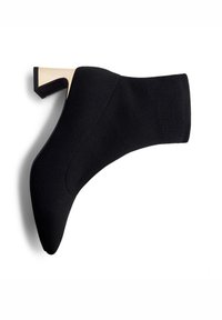 Stivale alla caviglia nero in maglia con punta affusolata e un distintivo tacco a blocco accentato in oro. Texture liscia, design elegante e vestibilità aderente.