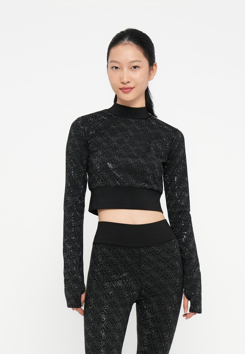 Svart kortermet topp med lange ermer og matchende tights med diamantmønster og subtil glans. Stoffet ser elastisk og tettsittende ut.