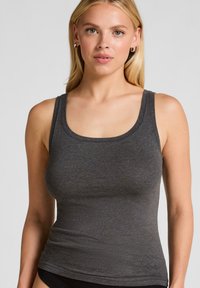 Grijze tanktop van een zachte, rekbare stof met een ronde halslijn en brede schouderbanden, met een strak aansluitende pasvorm.
