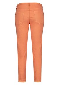 Orange denim pants with a slim fit, five pockets, and stitched detail along the waistband and hems. Smooth texture and clean finish.