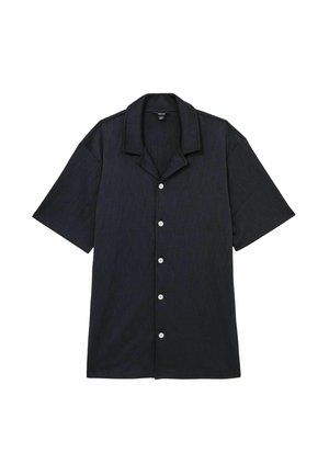 Camicetta con maniche corte e bottoni di colore blu scuro, con un delicato motivo testurizzato, caratterizzata da un colletto a camicia e cinque bottoni bianchi sul davanti.