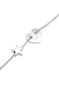 Armband aus Sterlingsilber mit einem Herz-Anhänger mit Ausschnitt und Sternakzent, beide poliert, an einer feinen Gliederkette. Mit "925" gestempelt.
