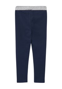 Leggings blu navy con un elastico argento a contrasto in vita. Realizzati in un tessuto morbido e elasticizzato, presentano una vestibilità slim e un design senza cuciture.