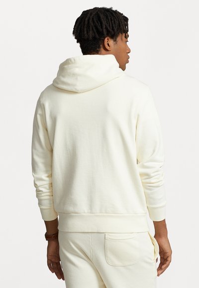 Crewneck hoodie in licht crème kleur, gemaakt van zachte stof met een relaxte pasvorm, voorzien van een capuchon met trekkoord en geribde manchetten.