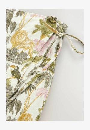 Textile featuring a tropical print with golden lions, toucans, and palm leaves in green and pink on a cream-colored background. Tied at the top.