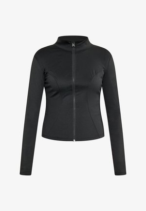 Mustan värviga sportlik jakke kõrge kaelusega, pikkade varrukatega ja keskmise tõmblukuga. Omab keha lähedast lõiget ja siledat kangast tekstuuri.
