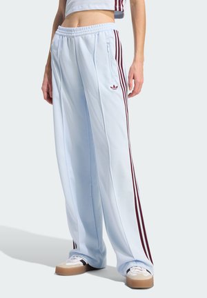 Light blue wide-leg pants with maroon side stripes and zip pockets, made from smooth fabric, featuring an Adidas logo at the hip.